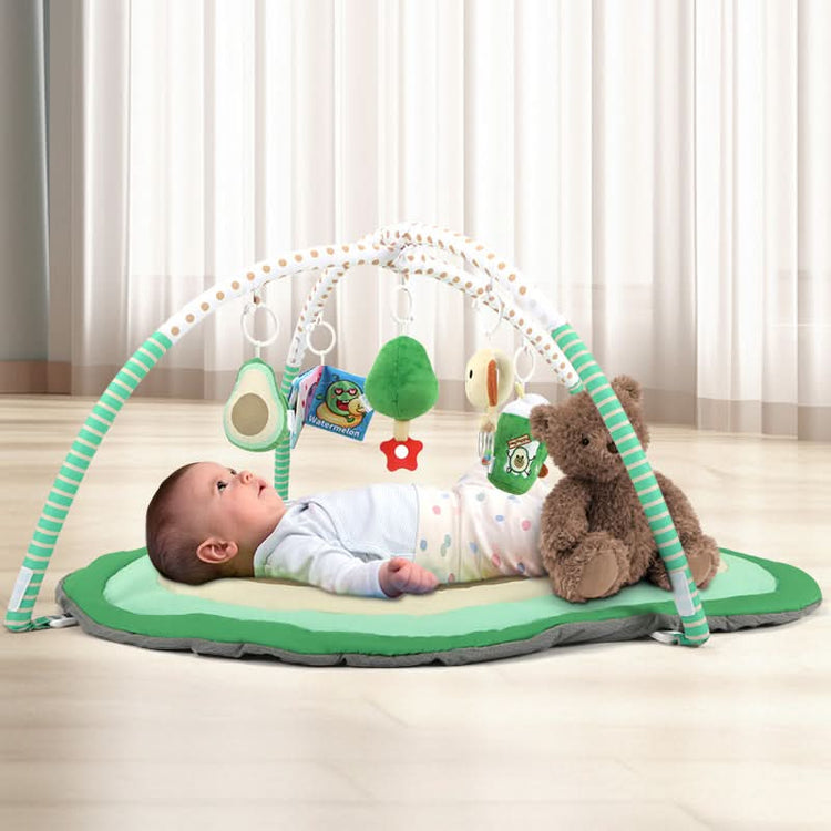 Baby lying on avocado play gym