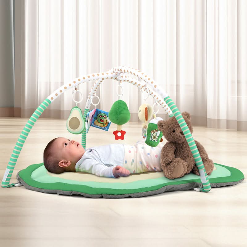 Baby lying on avocado play gym