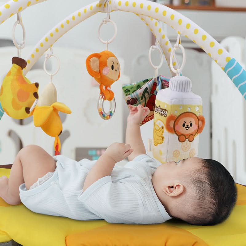 baby lying on banana play gym