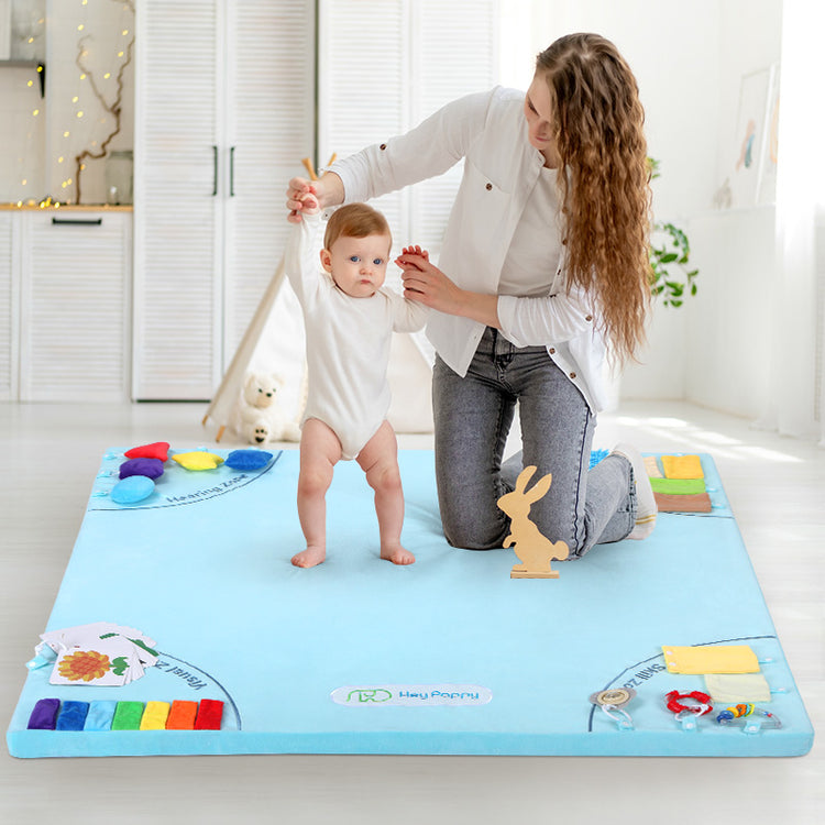 Baby practicing walking on sensory mat
