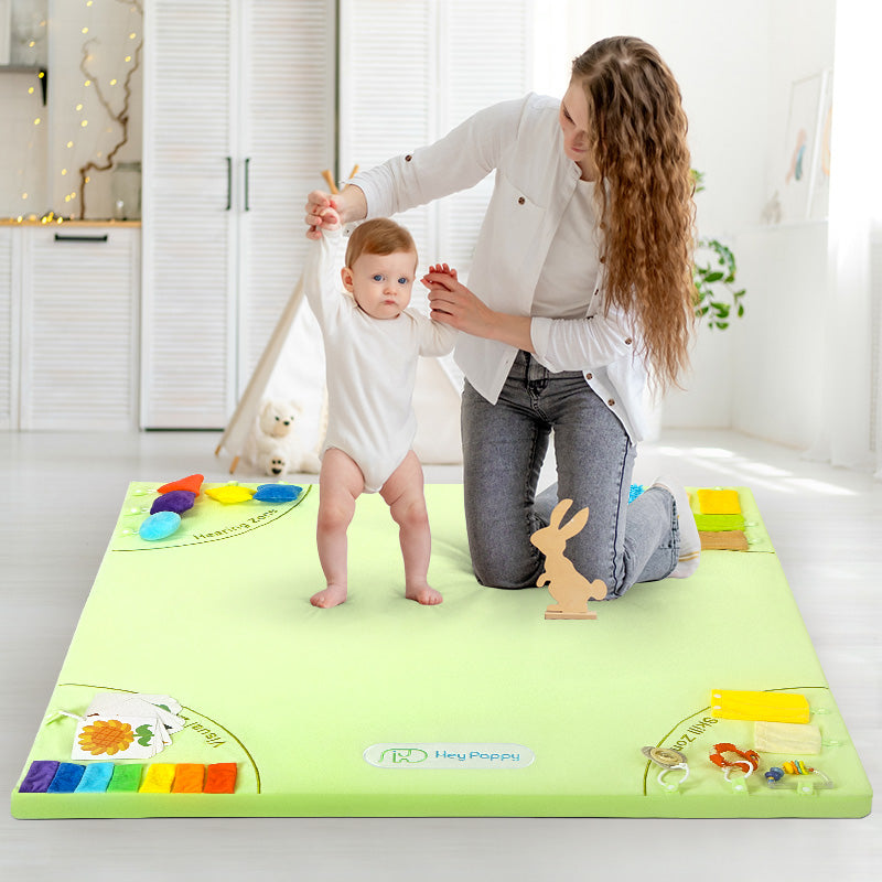 Baby practicing walking on the sensory mat