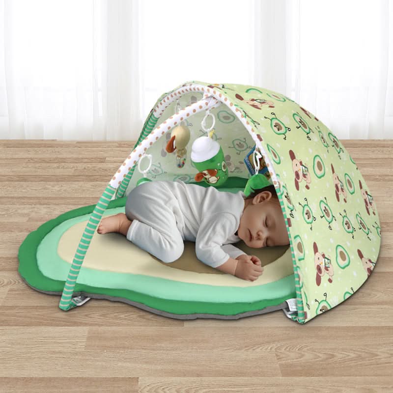Baby sleeping on avocado play gym