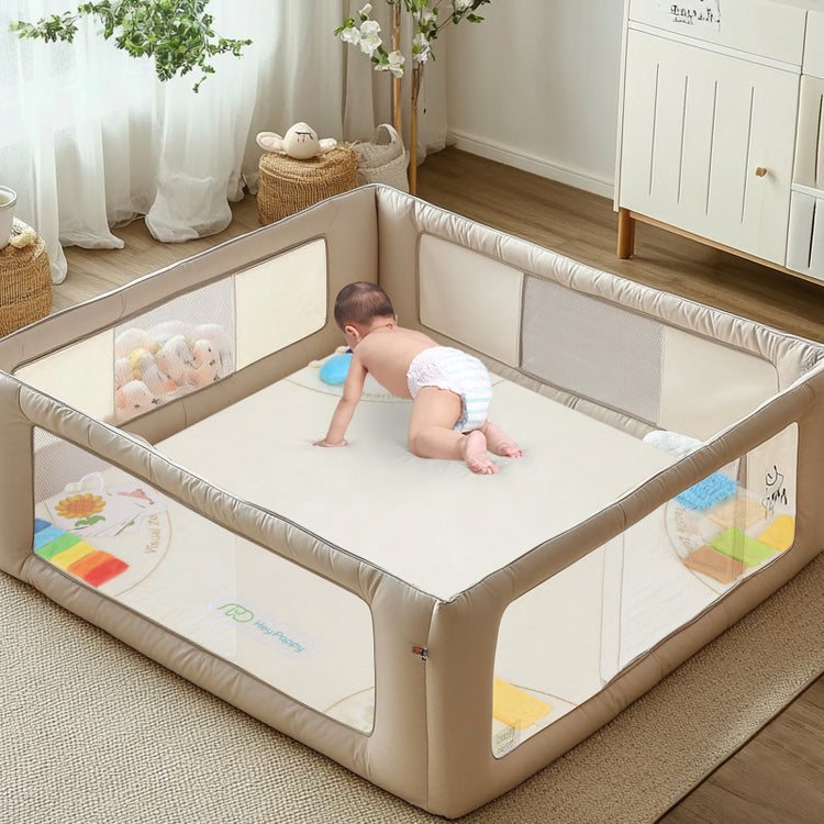 Baby climbing on the beige sensory mat