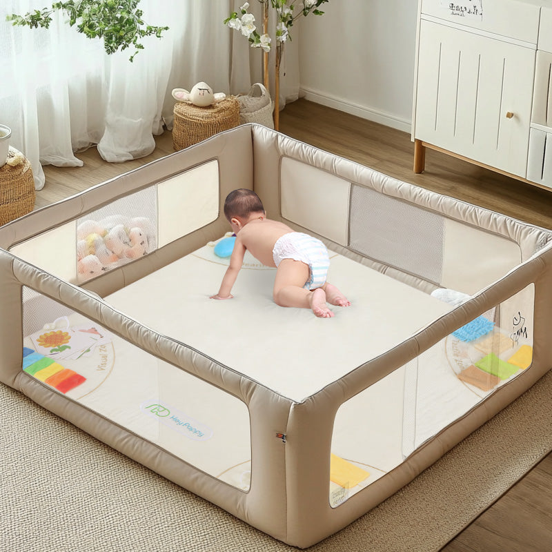Baby climbing on the beige sensory mat