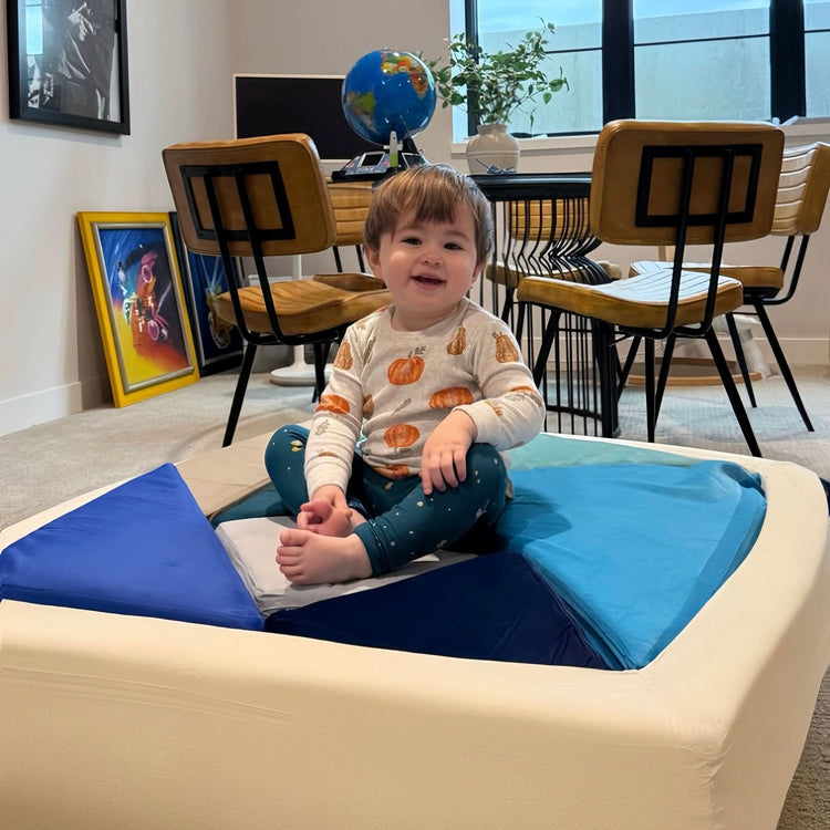baby sitting on puzzle Shaped Sofa