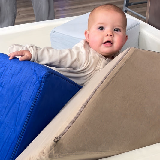 A baby lies on the tangram sofa