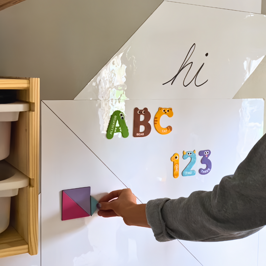 Tangrams stuck to magnetic board.